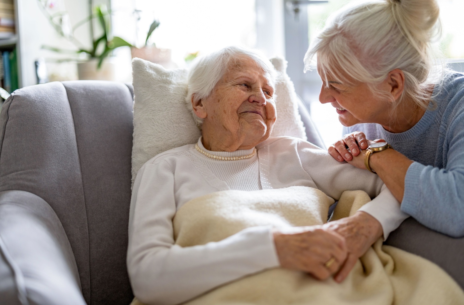 An older adult spending quality time with their mature parent in memory care