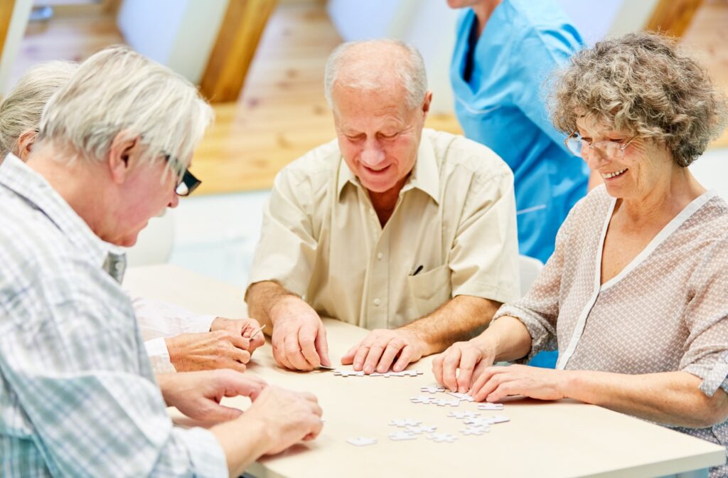 a group of seniors doing a puzzle together in assisted living